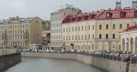 Russia, Saint Petersburg, 29 March 2017: The Moyka river, embankment, red  roof tops, yellow traditional buildings, calm