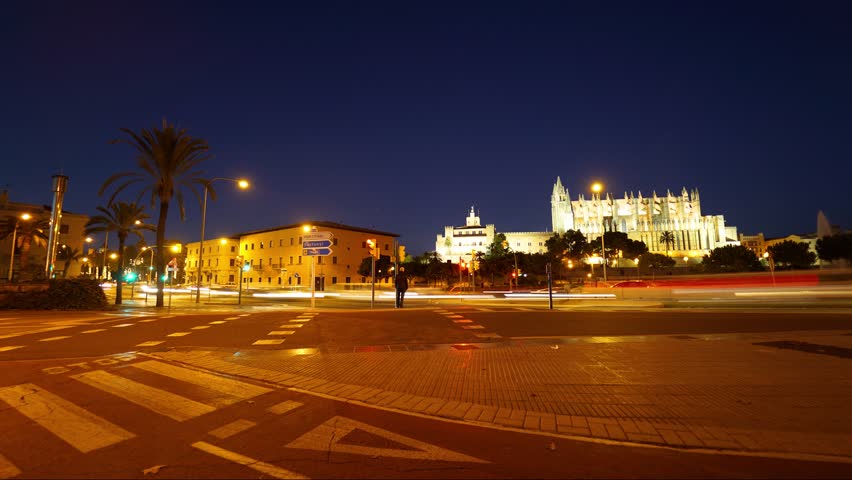 Time lapse of the beautiful city of Palma de Mallorca, Spain in front of the cathedral with passing traffic.