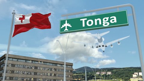 Tonga, approach of the aircraft to land in low-cloud weather, flying over the name of the country and its flag