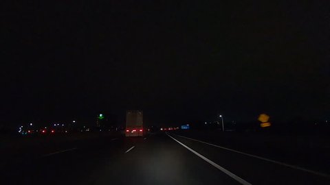 Toronto, Ontario, Canada December 2018 Driving plate car traffic POV on highway at night in on dark highway