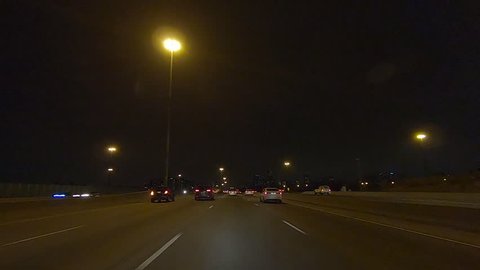 Toronto, Ontario, Canada December 2018 Driving plate car traffic POV on highway at night in on dark highway