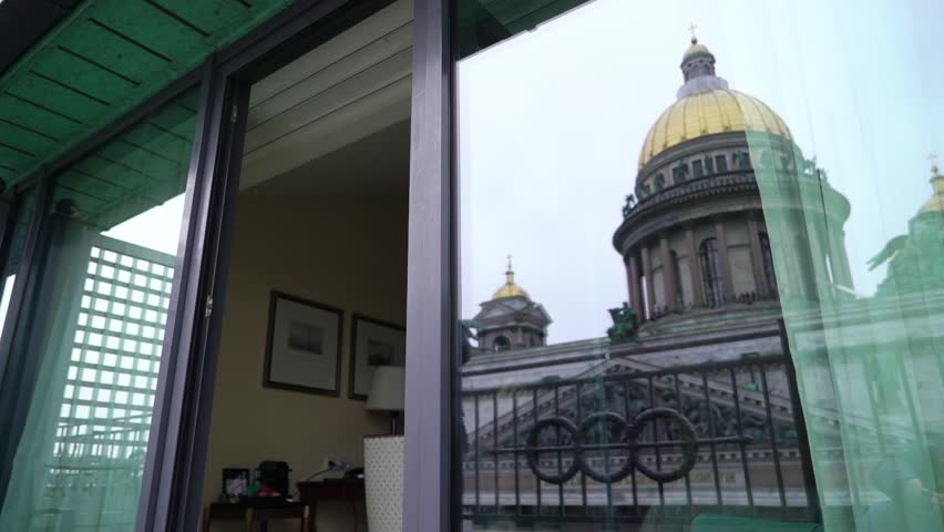 Young sexy brunette woman in lingerie staying in bedroom near window and posing. Flirting of lovely female in hotel room. Slow motion. Touching herself. Saint-Petersburg and Isaacs Cathedral city