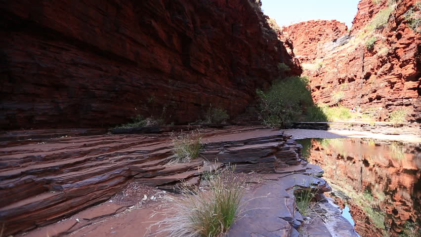 Beautiful amazing features scenic footage of iron ore rock formation mountains water reflection at Knox Gorge valley in Karijini National Park’s Perth Western of Australia