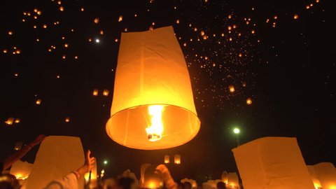 Yi Peng Lanna lanterns floating to night sky during festival in Chiang Mai, Thailand.