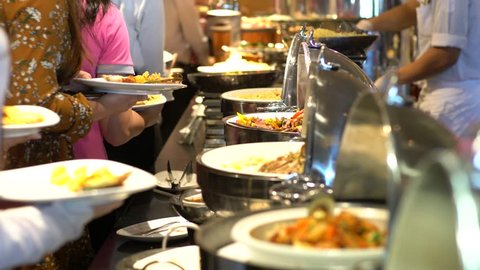 Food buffet catering lunch time seminar party with many hand of people in luxury restaurant