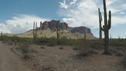 Apache Junction, AZ / USA - July 10, 2018: Shot of Saguaro Cactus and Superstition Mountains. Nature clip provides classic desert scene and Southwest imagery. 