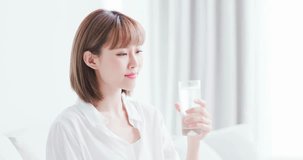 Beauty woman drink water and feel happily at home