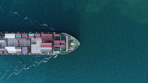 Aerial top view of cargo container ship vessel import export container in the ocean.