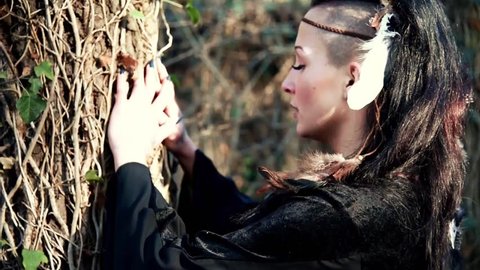 Beautyful Viking woman conjures a tree and nature