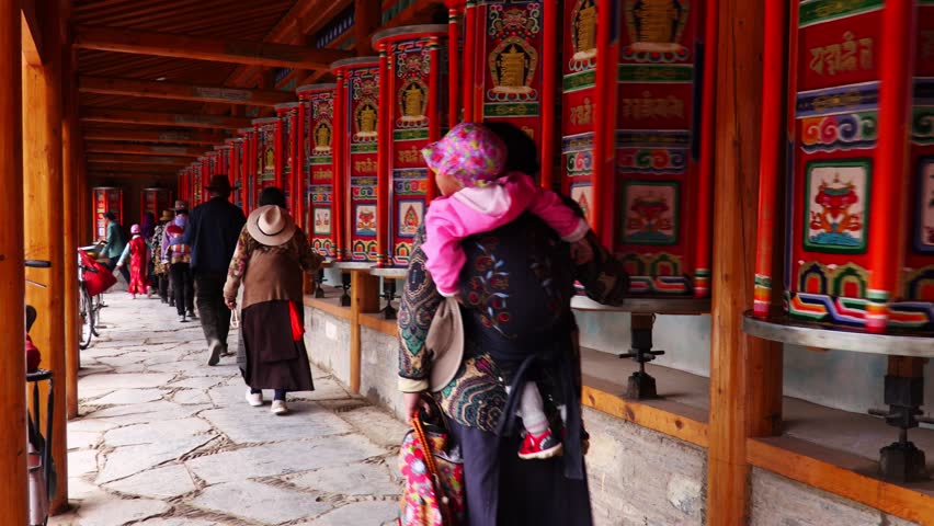 Buddhist pilgrims turning the prayer wheels, Eastern Tibet, China Royalty-Free Stock Footage #1021273282