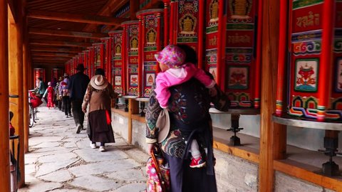 Buddhist pilgrims turning the prayer wheels, Eastern Tibet, China