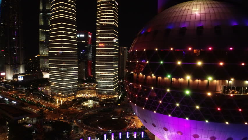 SHANGHAI, CHINA - SEPTEMBER 2018: Close drone shot of famous Oriental Pearl Tower with illuminated neon lights in modern financial district in Shanghai, China | Shutterstock HD Video #1021274785