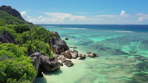 Aerial view of tropical paradise beach with white sand and turquoise crystal clear water of Indian Ocean - Anse Source d'Argent, La Digue Island, Seychelles