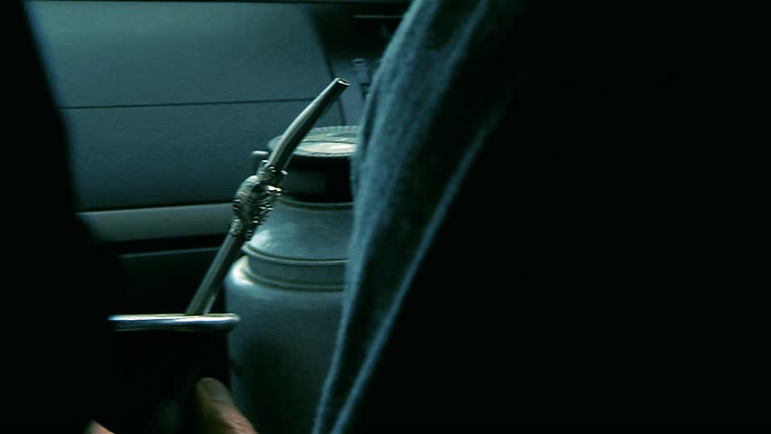 Man Holding Thermos Flask and Yerba Mate Inside Moving Car, Buenos Aires, Argentina - Close Up