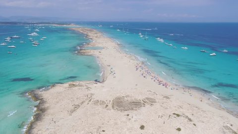 Aerial view over the lush rich beach of Formentera, with rich turquoise water and white sandy beach.