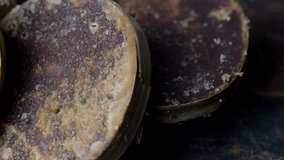 Close up footage of coconut palm sugar on wooden table. Selective focus.