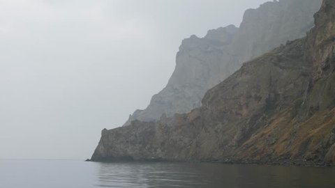 boat trip along the coastal cliffs on a cloudy day