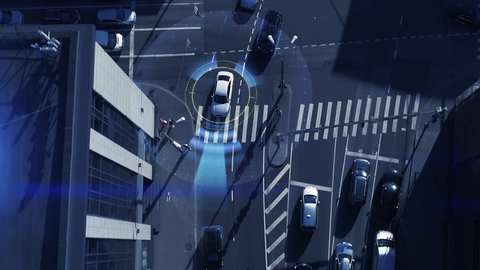 Top Down Aerial Drone: White Autonomous Self Driving Car Moving Through City. Concept: Artificial Intelligence Scans Surrounding Environment, Detecting Cars, Avoids Traffic Jams and Drives Safely.