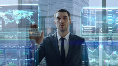 Futuristic Concept: Businessman or Stock Brocker Uses with Gestures Transparent Display Showing Various Infographics, Statistics and Data.