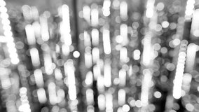 Black and white shiny holiday background. Bokeh of defocused lights of street Christmas garland. Real time full hd video footage.