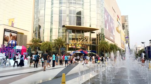BANGKOK, THAILAND - DECEMBER 21, 2018: Timelapse footage of asian thai people and tourists Walking and Shopping in Paragon Shopping Center Square at Siam BTS Subway Train Station. Bangkok, Thailand