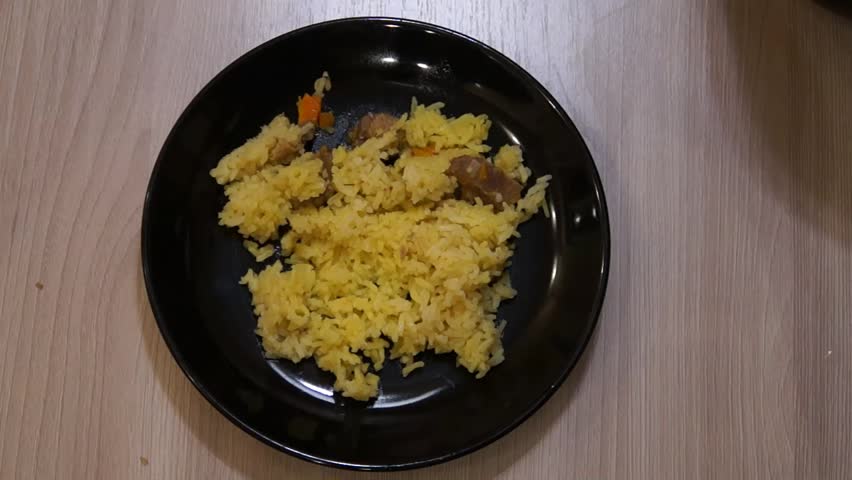 Chef cooking pilaf. Cooking process. National food. Rice and meat. Pilau