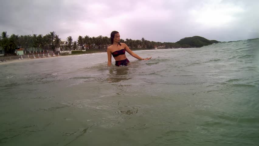 Women jumping in ocean waves. 