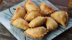 Malaysian desert pastry curry puff or locally known as 'karipap' on wooden table top.