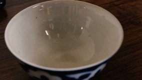 Close up of hot green tea pouring into asian uzbek national dish bowl. Tea drinking in Uzbekistan