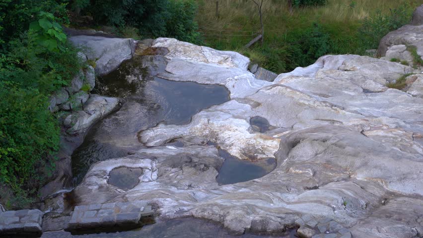 Waterfall pond near the little town Biasca, between Swiss mountains in Tessin, Switzerland