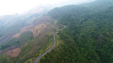 Nan Province in Thailand Drone , Aerial view of countryside road surrounded by the beautiful mountain forrest 