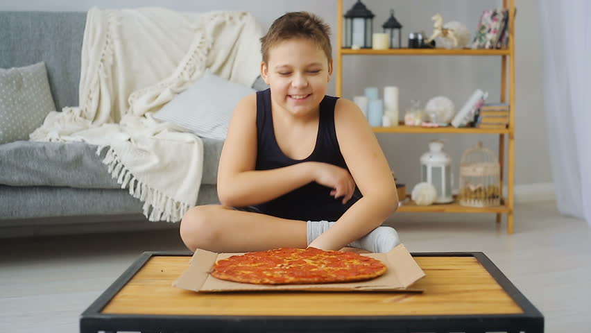 fat boy eating pizza