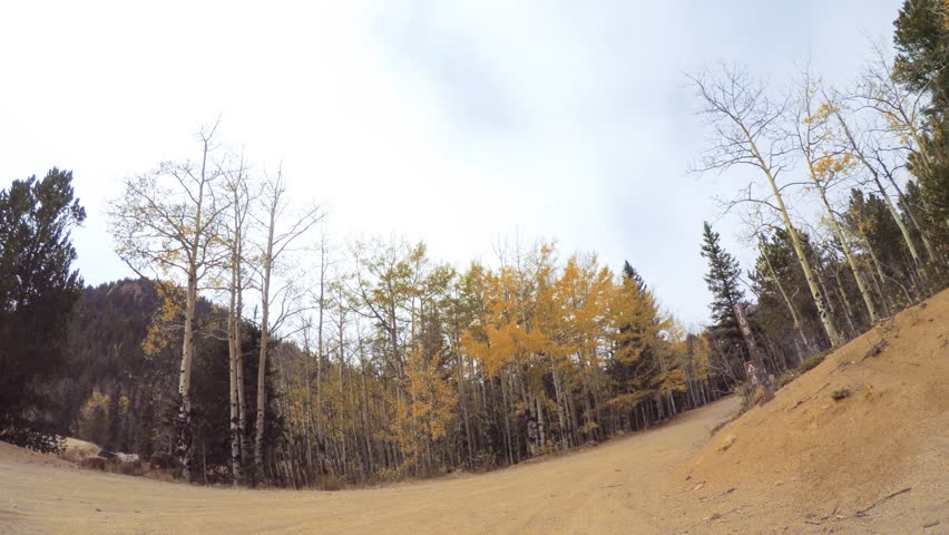 Driving on small mountain dirt roads from Colorado Springs to Cripple Creek in Autumn.