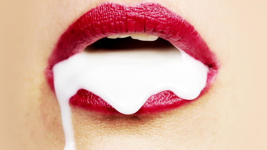 Female beautiful red lips with white liquid slowly dripping out the mouth S...