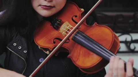 Violin concert. Musician playing violin outdoors. Violinist play music close up.