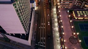 Aerial drone footage of New York skyline along 42nd street canyon, at dusk, with camera uptilt movement (logos and signs blurred)