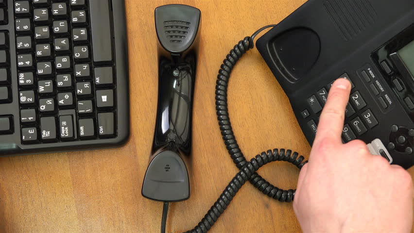 Index finger presses numbers on landline phone. | Shutterstock HD Video #1021369744