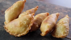 Malaysian desert pastry curry puff or locally known as 'karipap' on wooden table.