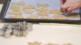 Cooking festive cookies at home on the table with mom with children's hands. HD video close up.