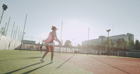 Young females playing tennis game on the full tennis court.shot on red epic. 4k