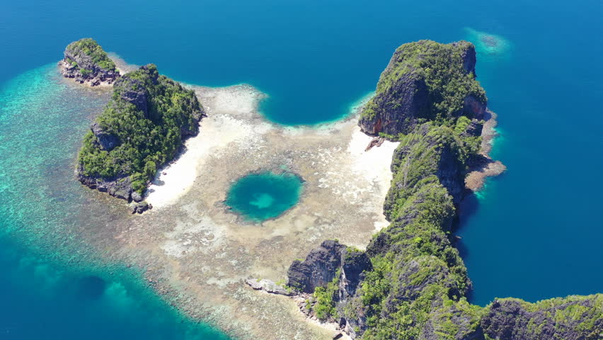 Reefs uplifted millions of years ago formed limestone islands in Raja Ampat, Indonesia. This biodiverse, remote region is known as the "heart of the Coral Triangle" due to its amazing marine life.