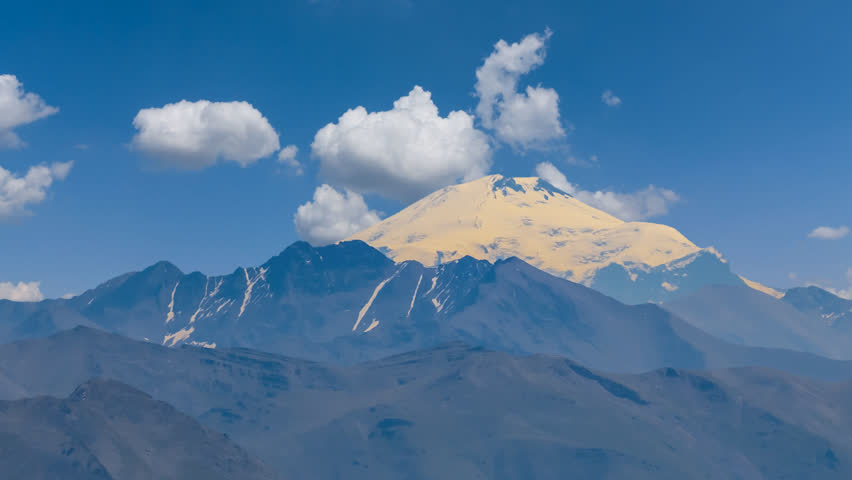 Elbrus mount on a cloudy sky background time lapse scene