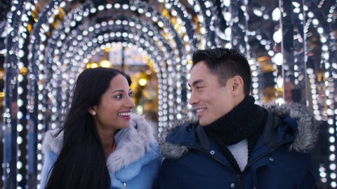 Happy mixed young couple walking and share a kiss, in slow motion Stock Video