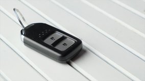 Keyless car remote control on wooden white board.