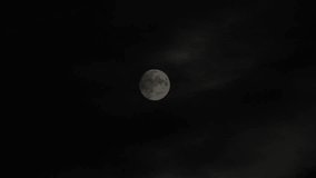 Moon with clouds moving on sky, 4k closeup video at night