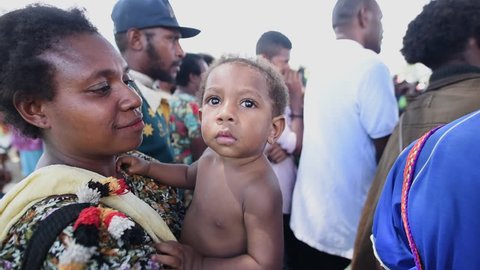 Vanimo, Papua New Guinea - 05 19 2017: Slow Motion Mother In Vanimo Papua New Guinea Holding Young Child In Her Arms