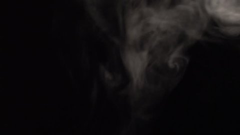 Slow motion video clip footage isolated black background of overlay flowing active white cloud, fog, gas and smoke beginning until end (fade in and fade out) empty copy space for text and content  
