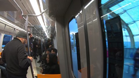 Istanbul, Turkey - October 2018: Commuters inside istanbul metro wagon travelling towards Taksim station