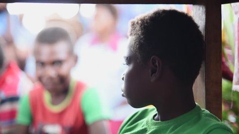 Rabaul, Papua New Guinea - 05 19 2017: Slow Motion Young Boy In Rabaul Papua New Guinea Turns And Looks At Camera