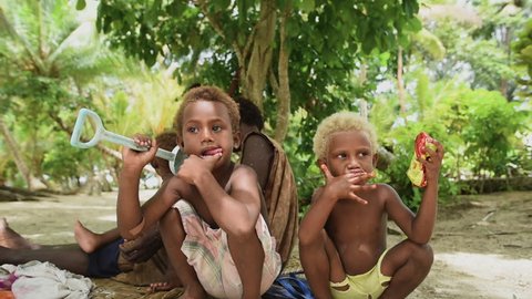 Rabaul, Papua New Guinea - 05 19 2017: Young Children Sitting On Beach In Rabaul Papua New Guinea